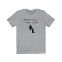 I'm Not Single I Have A Dog - Image Description - Heather Grey t-shirt with I'm Not Single, I have a dog in black text with a red paw print in place of the O in dog. Under the saying, a black silhouette of a woman standing next to a sitting boarder collie dog silhouette. 