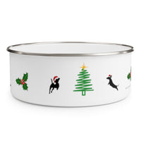 Dogs Holiday Cheer Enamel Bowl - White bowl with stainless steel rim decorated with a holly with 3 berries, silhouettes of 2 dogs wearing santa hats jumping towards a green line Christmas tree with a yellow star.