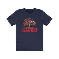 Image Description: Navy crew neck t-shirt. Orange and red maple leaves  on a brown tree trunk with a small black dog walking beside the tree trunk.  The www.DogsandTheirPaws.com url is under the tree.  The phrase, "Leaves are falling.  Autumn is calling." is below the image of the tree is in red.  