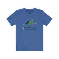 Tumbled Christmas Tree Unisex Jersey Tee - Royal Blue t-shirt with a picture of a line Christmas tree on it's side and a black silhouette dachshund jumping on the tree with several red and green ornaments falling off the tree