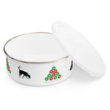 Sit Sniff Christmas Enamel Bowl - Image Description - Overhead view of a white bowl with a lid leaning against the bowl and an image with a silhouette of  a black dog with a green collar sniffing the ground next to a pyramid of red and green ornaments  on the other side a partial image of a black dog sitting