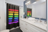 Acceptance Has No Limits black shower curtain with a black dog sitting in front of 7 horizontal lines  in the rainbow colors covering a white tub in a bathroom with a double vanity and large mirror.
