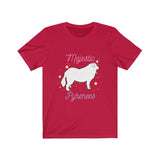 Majestic Pyrenees Jersey Tee - Image Description Red t-shirt with a white cartoon drawing of a Great Pyrenees standing with yellow circles and stars around the dog. The wording Majestic is pink and Pyrenees is a light blue.