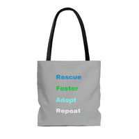 Blue Rescue Foster Adopt Repeat Tote Bag Image Description: Grey tote with black handles displaying the following words:  Rescue (Blue), Foster (Green), Adopt (turquoise) Repeat (White) 