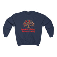 Image Description: Navy crew neck sweatshirt. There are orange and red maple leaves  on a brown tree trunk with a small black dog walking beside the tree trunk.  The www.DogsandTheirPaws.com url is under the tree.  The phrase, "Leaves are falling.  Autumn is calling." is below the image of the tree is in red.  