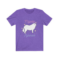Majestic Pyrenees Jersey Tee - Image Description Light purple t-shirt with a white cartoon drawing of a Great Pyrenees standing with yellow circles and stars around the dog. The wording Majestic is pink and Pyrenees is a light blue.