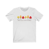 Image Description:  White crew neck T-shirt with a row of 6 trees in yellow, orange and red with paw prints going into the middle with the dogs and their paws url with the words "Autumn Leave and Paw Prints Please" below the line of trees and paw prints.