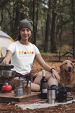 Image Description: woman sitting with her golden retriever cooking at  a campsite wearing the white Autumn Leaves and Paw Prints Please t-shirt